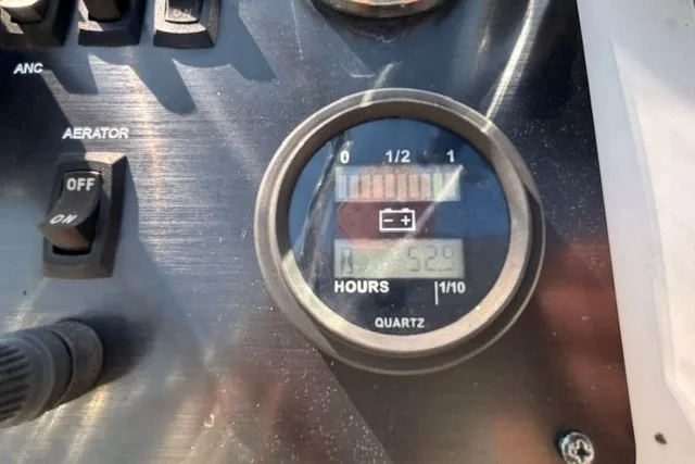 Slide: The Image of Control panel of a 2019 G3 Bay 20 boat showing hour meter and switches. - 20