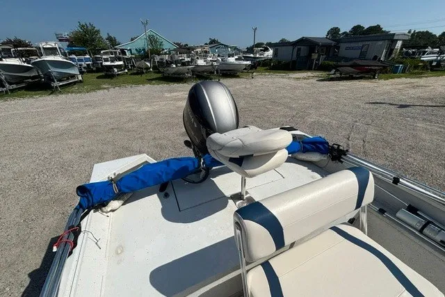 Slide: The Image of 2019 G3 Bay 20 boat with motor, parked in a marina with other boats. - 34