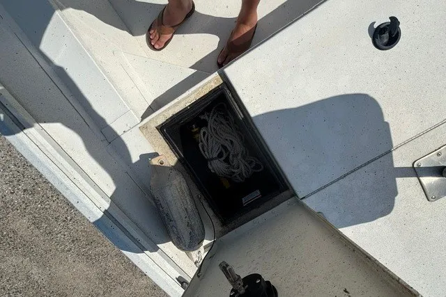 Slide: The Image of Open storage compartment on a 2019 G3 Bay 20 boat with rope and fender. - 14