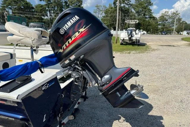 Slide: The Image of Boat with Yamaha outboard motor, G3 Bay 20 model, 2019, parked on gravel lot. - 27