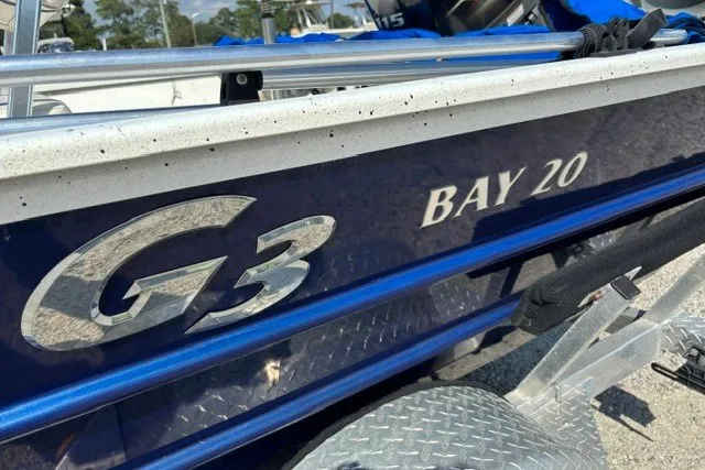 Slide: The Image of G3 Bay 20 boat, 2019 model, with metallic blue exterior and visible branding. - 26