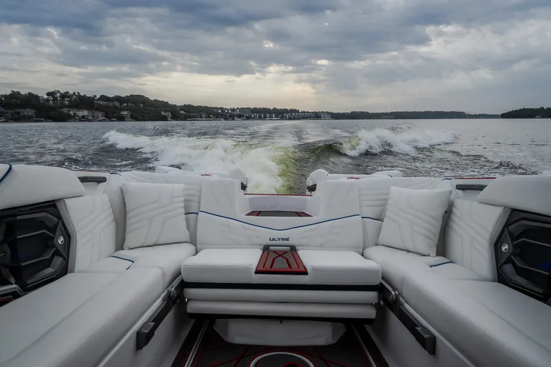 Slide: The Image of Luxurious interior of 2027 Tige Ultré 25ZX boat cruising on a scenic lake. - 12