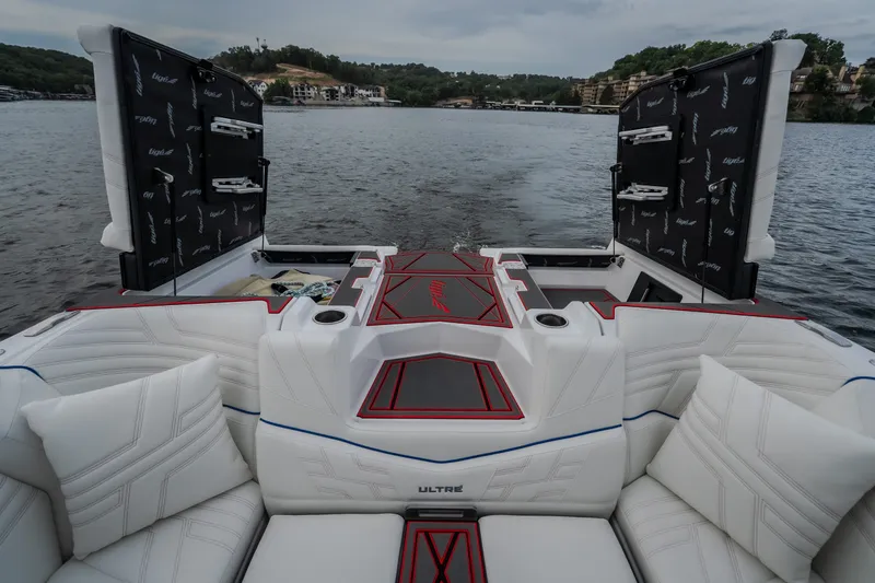 Slide: The Image of 2027 Tigé Ultré 25ZX boat interior with luxurious seating on a scenic lake. - 44