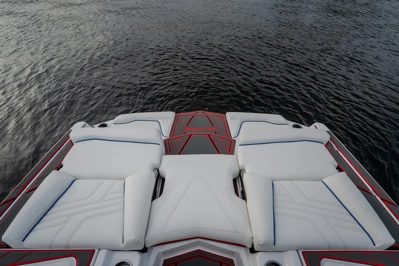 Slide: The Image of 2027 Tige Ultré 25ZX boat with luxurious white seating on calm water. - 36
