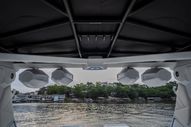 Slide: The Image of 2027 Tige Ultré 25ZX boat speakers with lake view in the background. - 33