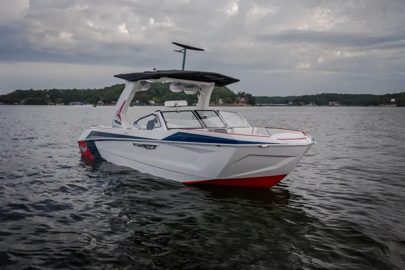 Slide: The Image of 2027 Tige Ultré 25ZX boat on calm water under cloudy sky. - 2