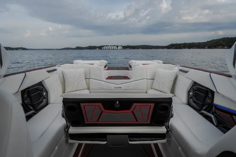 Slide: The Image of Luxurious interior of 2027 Tigé Ultré 25ZX boat on a serene lake. - 60