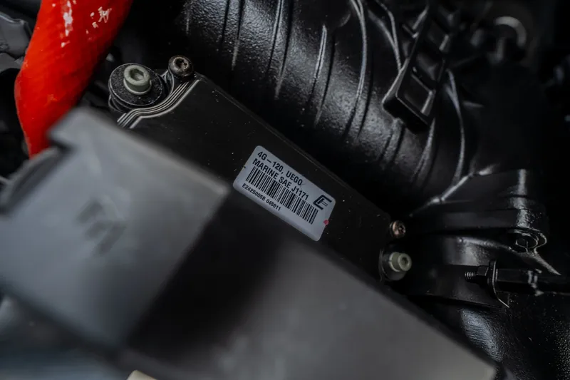 Slide: The Image of Close-up of 2027 Tigé Ultré 25ZX engine component with label and red cable. - 50