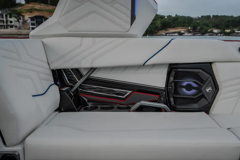 Slide: The Image of Interior of 2027 Tige Ultré 25ZX boat featuring sleek white seating and integrated speaker system. - 29