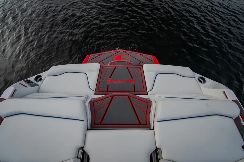 Slide: The Image of 2027 Tige Ultré 25ZX boat interior with sleek white and red design on water. - 37