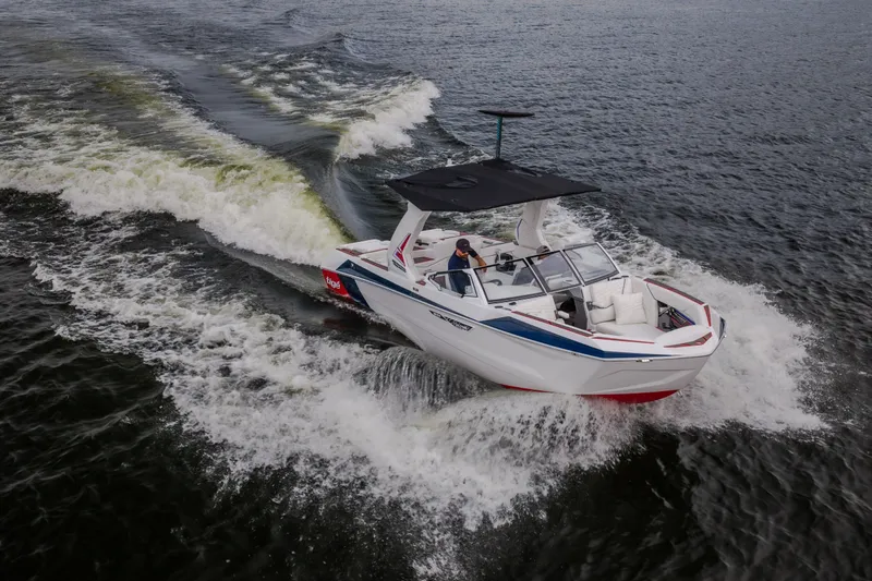 Slide: The Image of 2027 Tige Ultré 25ZX boat cruising on open water, creating dynamic waves. - 8