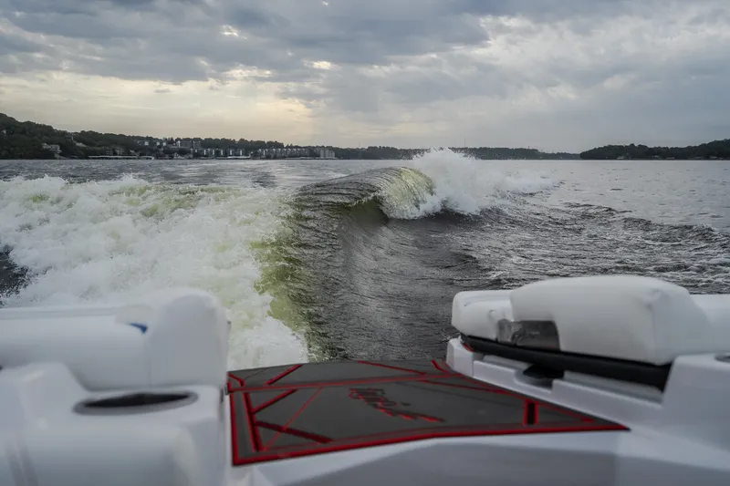 Slide: The Image of 2027 Tige Ultré 25ZX creating waves on a cloudy lake. - 13
