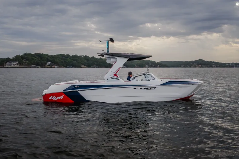 The Image of 2027 Tige Ultré 25ZX boat on a lake under cloudy skies. - 1