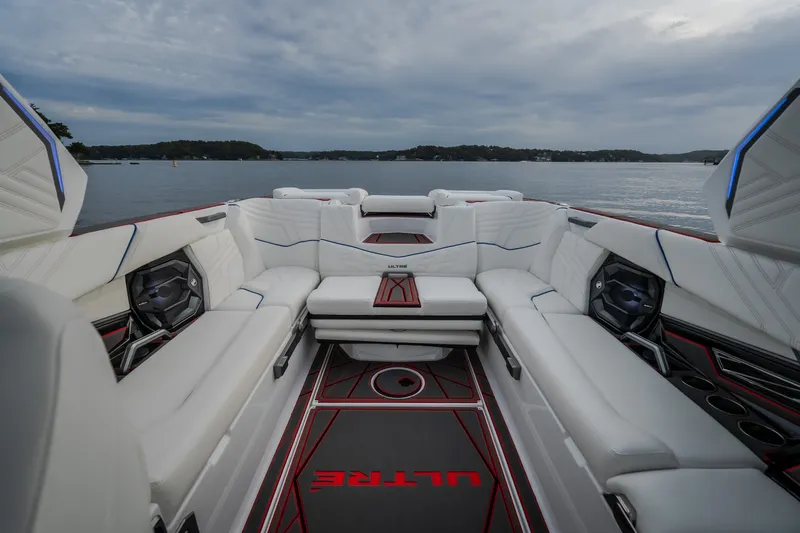 Slide: The Image of Luxurious interior of 2027 Tige Ultré 25ZX boat with white seating and lake view. - 30