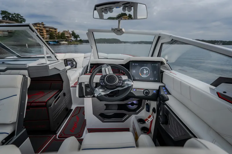 Slide: The Image of Interior view of 2027 Tige Ultré 25ZX boat with modern dashboard and steering. - 23