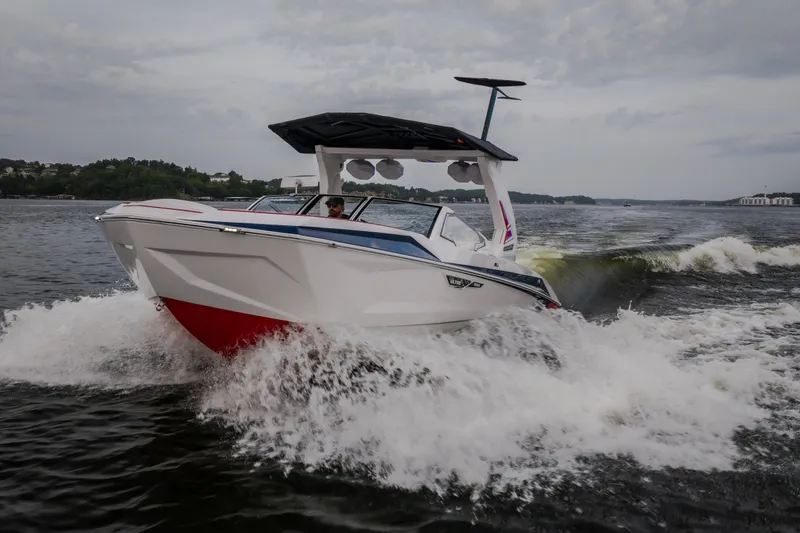 Slide: The Image of 2027 Tige Ultré 25ZX boat cruising on a lake, creating dynamic waves. - 9