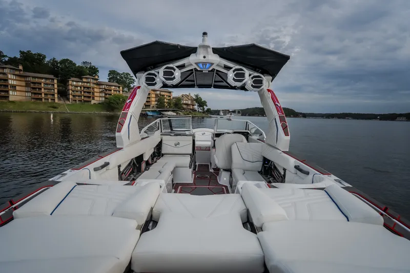 Slide: The Image of Luxurious 2027 Tige Ultré 25ZX boat interior with plush seating on a serene lake. - 38