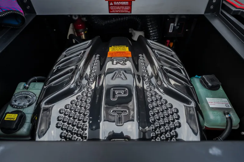 Slide: The Image of 2027 Tigé Ultré 25ZX engine compartment with Raptor branding and emission labels. - 49