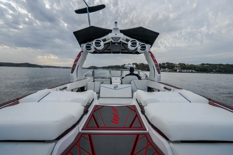 Slide: The Image of 2027 Tigé Ultré 25ZX boat on water, featuring sleek design and spacious seating. - 53