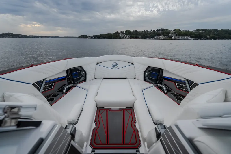 Slide: The Image of Luxurious interior of 2027 Tigé Ultré 25ZX boat with white seating and scenic lake view. - 58