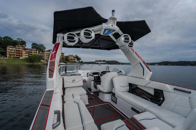 Slide: The Image of 2027 Tige Ultré 25ZX boat interior with luxury seating and advanced sound system on a serene lake. - 42