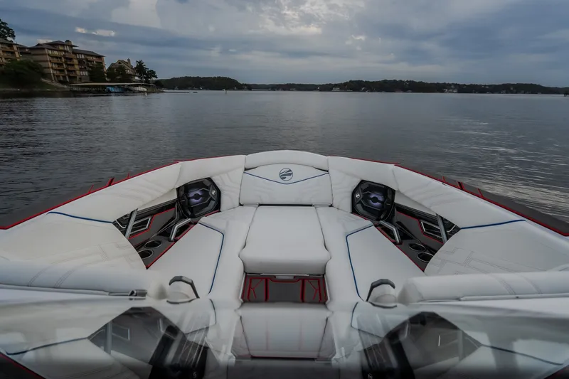Slide: The Image of Luxurious interior of 2027 Tigé Ultré 25ZX boat on a serene lake. - 63