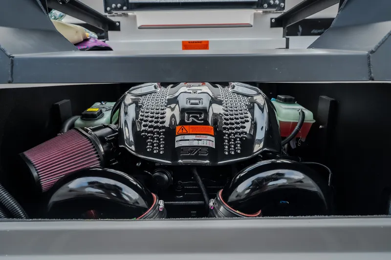 Slide: The Image of Engine compartment of 2027 Tigé Ultré 25ZX boat, showcasing powerful motor design. - 48