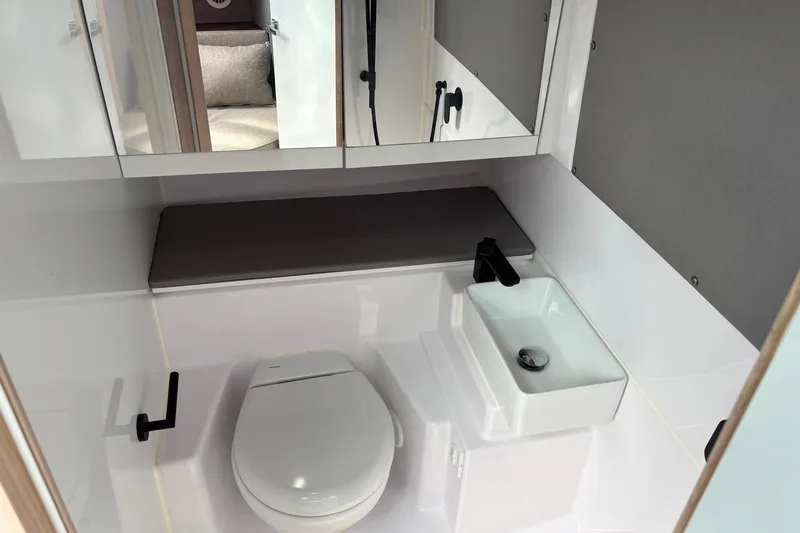 Slide: The Image of Modern bathroom in 2023 Axopar 45 XC Cross Cabin boat, featuring sleek fixtures and compact design. - 27
