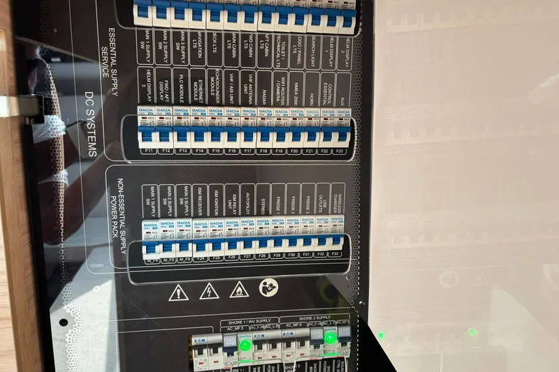 Slide: The Image of Electrical panel of 2023 Axopar 45 XC Cross Cabin, showcasing essential and non-essential DC systems. - 14