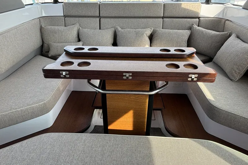 Slide: The Image of Luxurious interior of 2023 Axopar 45 XC Cross Cabin with elegant seating and wooden table. - 19