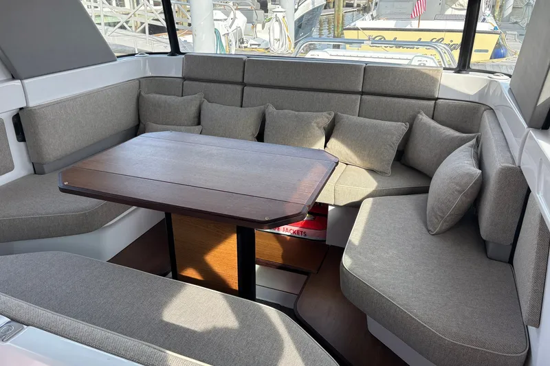 Slide: The Image of Luxurious seating area in 2023 Axopar 45 XC Cross Cabin boat with cushions and table. - 18