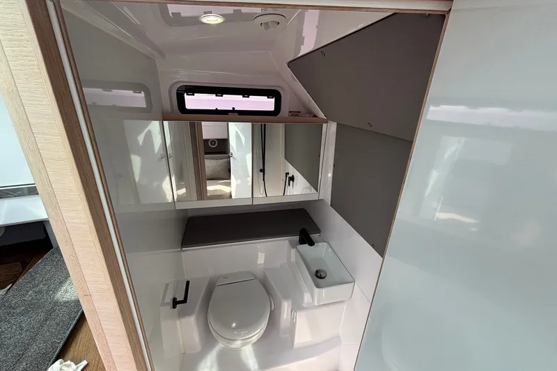 Slide: The Image of Modern bathroom interior of 2023 Axopar 45 XC Cross Cabin boat, featuring sleek design and compact fixtures. - 26