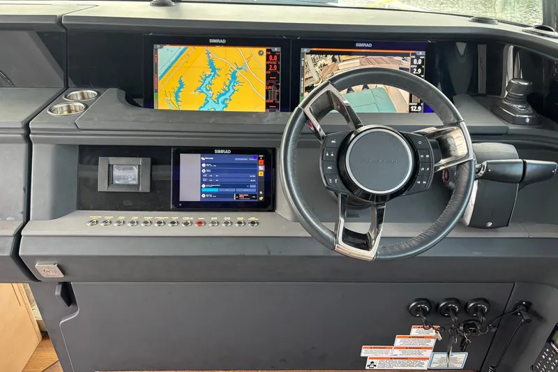 Slide: The Image of 2023 Axopar 45 XC Cross Cabin dashboard with navigation screens and steering wheel. - 8