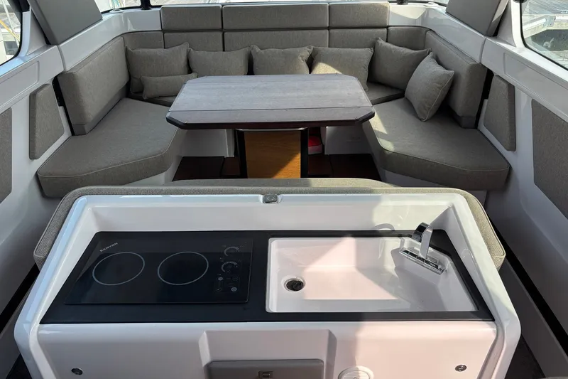 Slide: The Image of Interior of 2023 Axopar 45 XC Cross Cabin with kitchenette and seating area. - 17