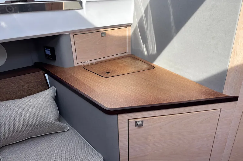 Slide: The Image of Interior of 2023 Axopar 45 XC Cross Cabin with wooden cabinetry and seating. - 22