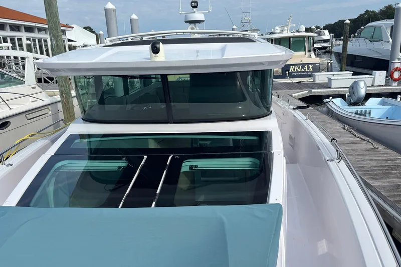 Slide: The Image of 2023 Axopar 45 XC Cross Cabin docked at a marina, showcasing sleek design and modern features. - 31