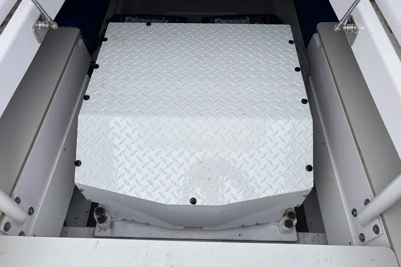 Slide: The Image of Engine compartment of 2023 Axopar 45 XC Cross Cabin with diamond plate cover. - 29