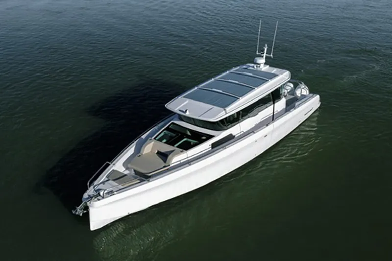 Slide: The Image of 2023 Axopar 45 XC Cross Cabin cruising on calm waters. - 3