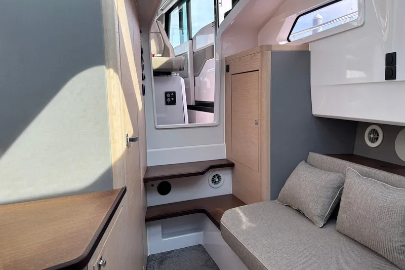 Slide: The Image of Interior of 2023 Axopar 45 XC Cross Cabin, featuring modern seating and wooden accents. - 24