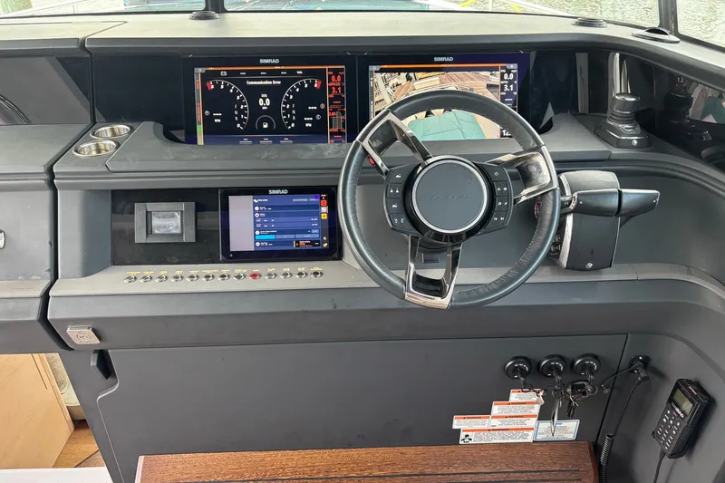 Slide: The Image of 2023 Axopar 45 XC Cross Cabin dashboard with steering wheel and digital displays. - 7