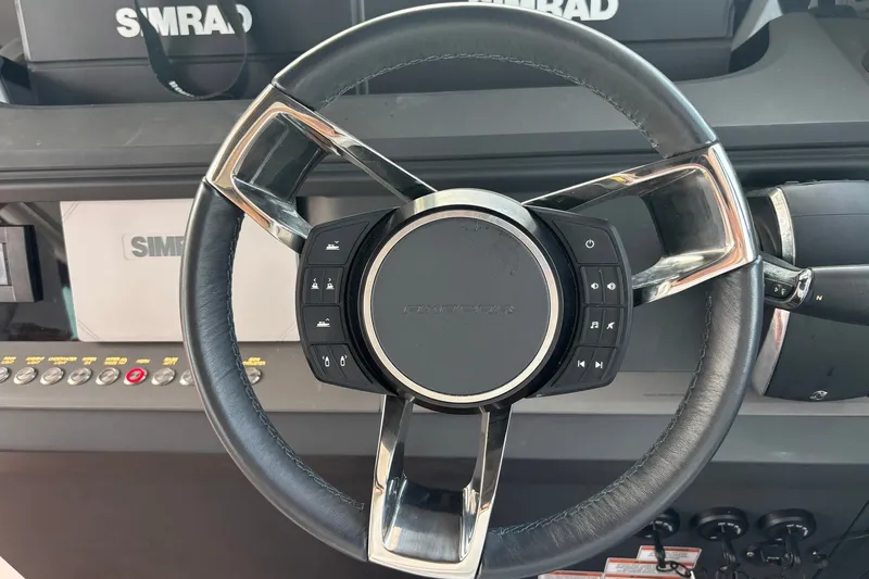 Slide: The Image of Steering wheel of 2023 Axopar 45 XC Cross Cabin with control buttons. - 11
