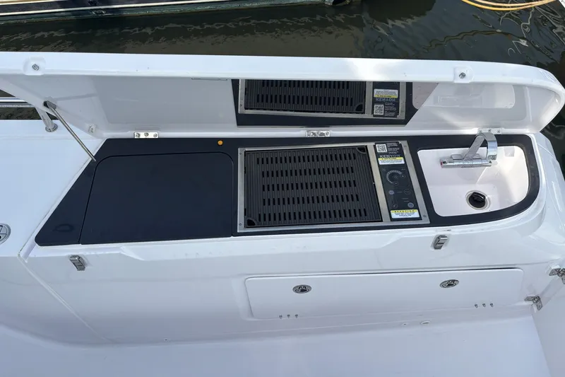 Slide: The Image of Outdoor kitchen on 2023 Axopar 45 XC Cross Cabin boat with grill and sink. - 38