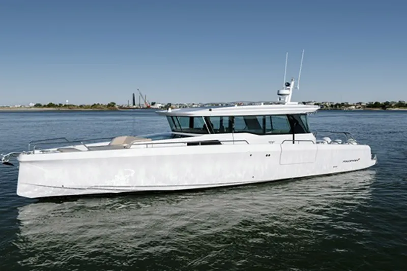 Slide: The Image of 2023 Axopar 45 XC Cross Cabin boat cruising on calm waters. - 4