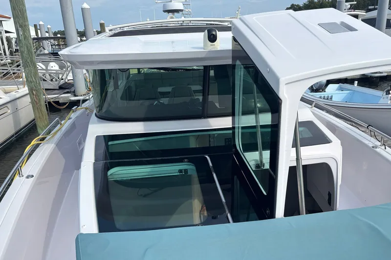 Slide: The Image of 2023 Axopar 45 XC Cross Cabin boat docked, showcasing sleek design and modern features. - 36