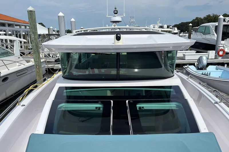 Slide: The Image of 2023 Axopar 45 XC Cross Cabin docked at a marina, showcasing sleek design and modern features. - 33