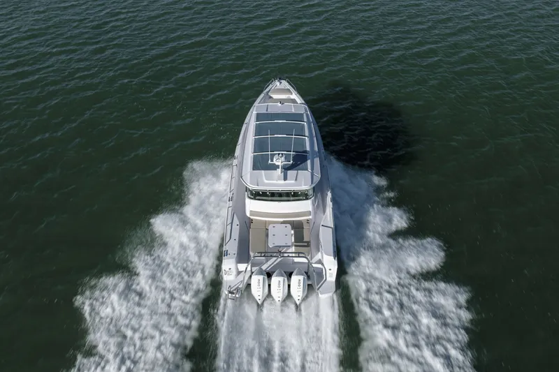 Slide: The Image of 2023 Axopar 45 XC Cross Cabin cruising on open water, aerial view. - 6