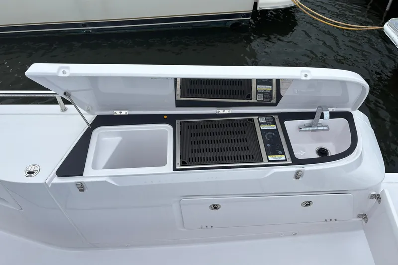 Slide: The Image of Outdoor kitchen on 2023 Axopar 45 XC Cross Cabin boat with sink and grill. - 39