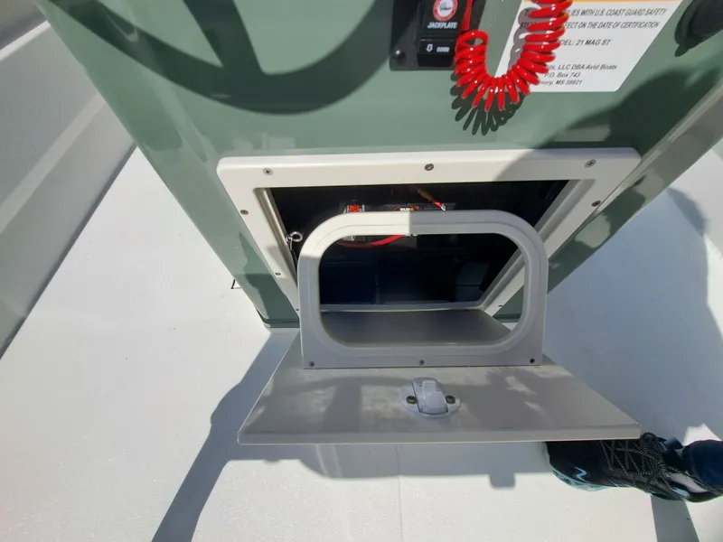 Slide: The Image of An open storage compartment on a boat with a red cable and a switch. - 29