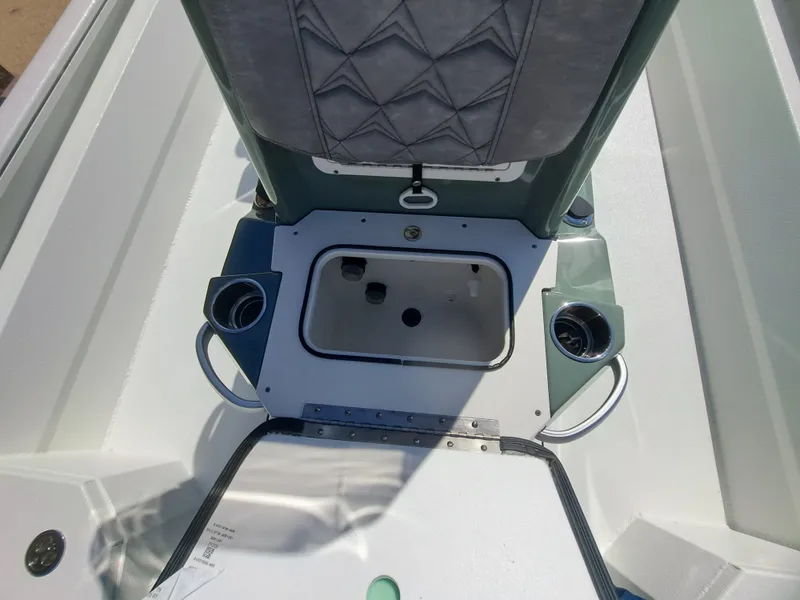Slide: The Image of The image shows the interior of a 2027 Avid 21MAG ST boat with a central storage area. - 24