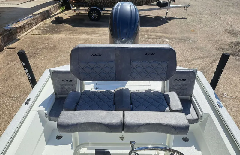 Slide: The Image of The image shows the cockpit of an Avid 21MAG ST boat with cushioned seating. - 6